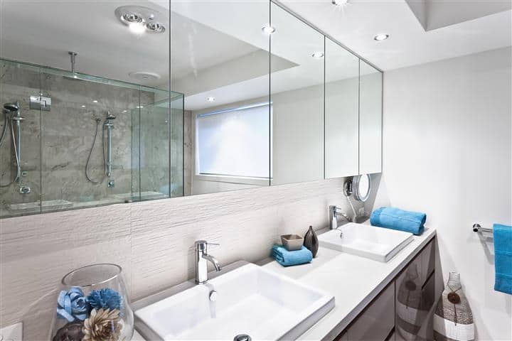 Master bathroom with row of vanity mirrors and long doubled sink counter