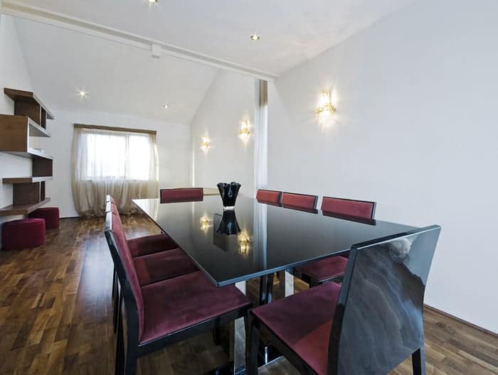 Glass tabletop and other modern furnishings in dining room