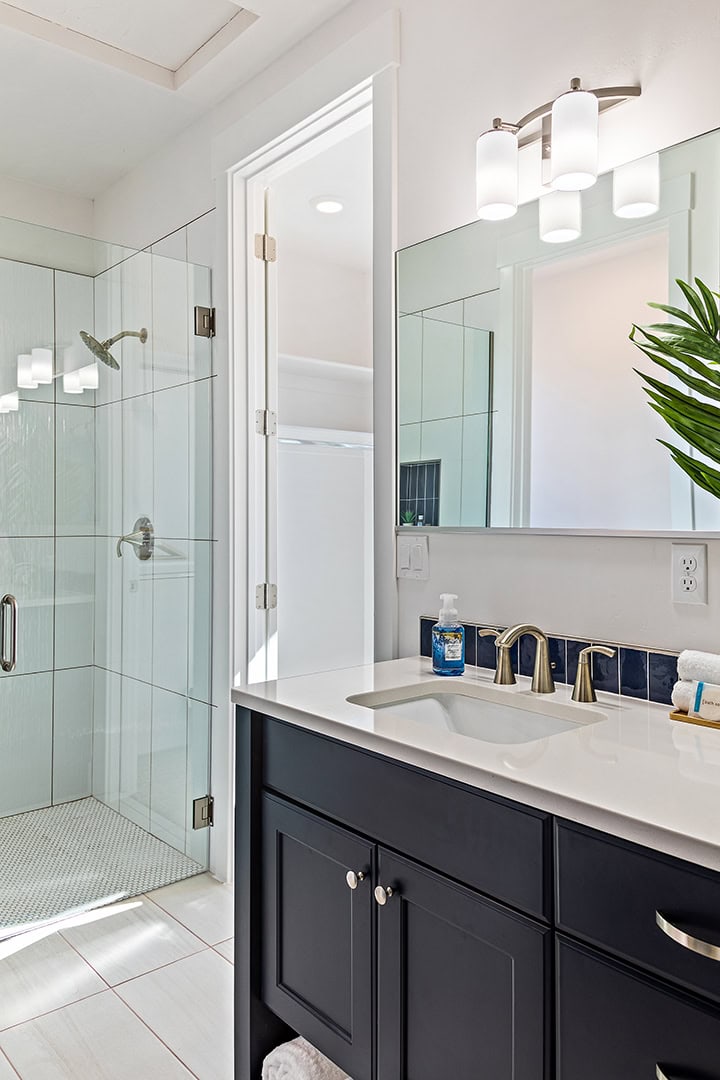 Modern custom frameless glass shower in utah home with vanity in the forefront