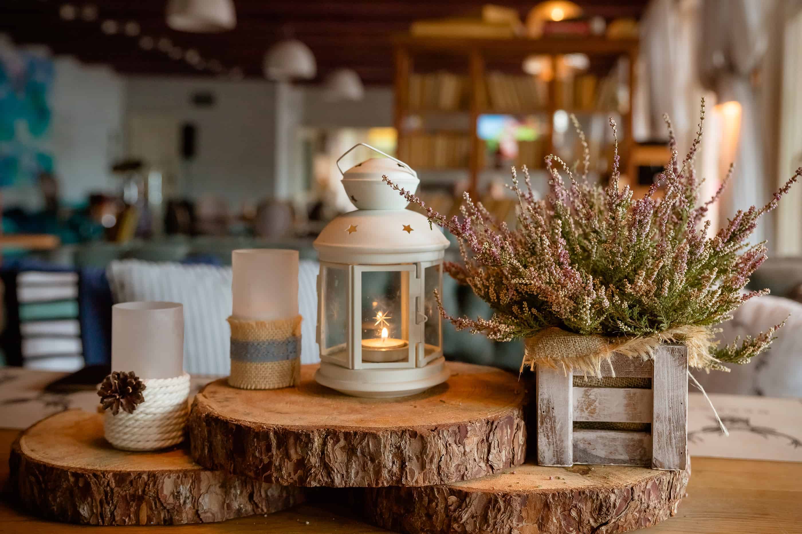 Example of vintage chic home decorating style with antique candle holder, rustic box with dried flowers, and wooden decorations