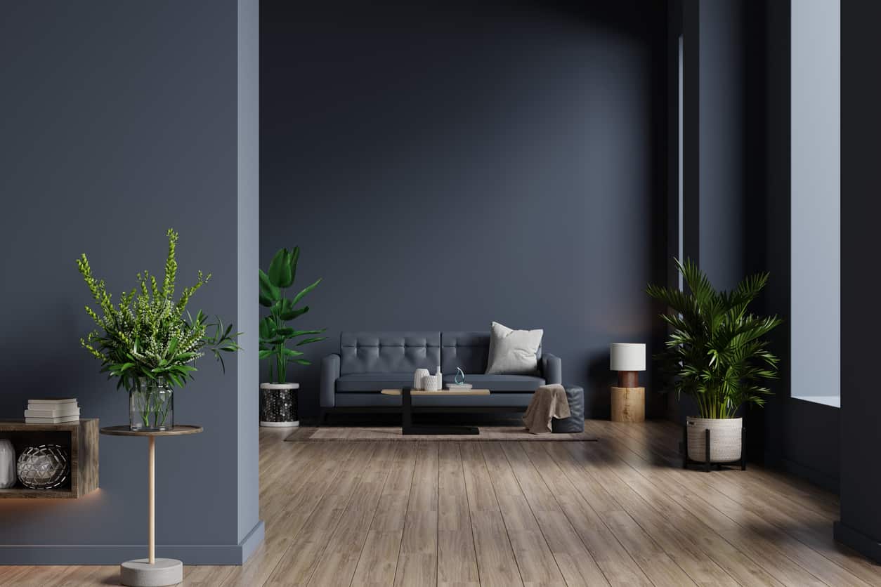 Dark blue 2023 paint trend living room with natural wood elements and houseplants