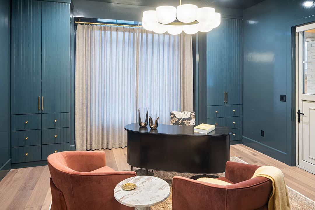 Beautiful home office in St. George with teal wall paint and coral couches.