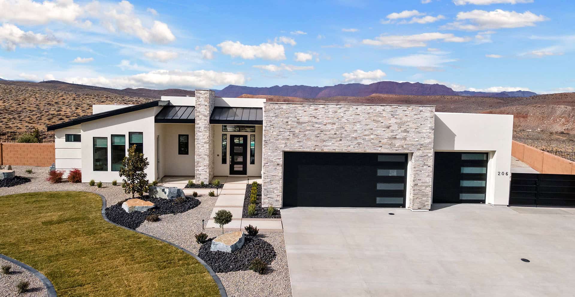 Gorgeous modern desert. home exterior with stylish three-car garage doors