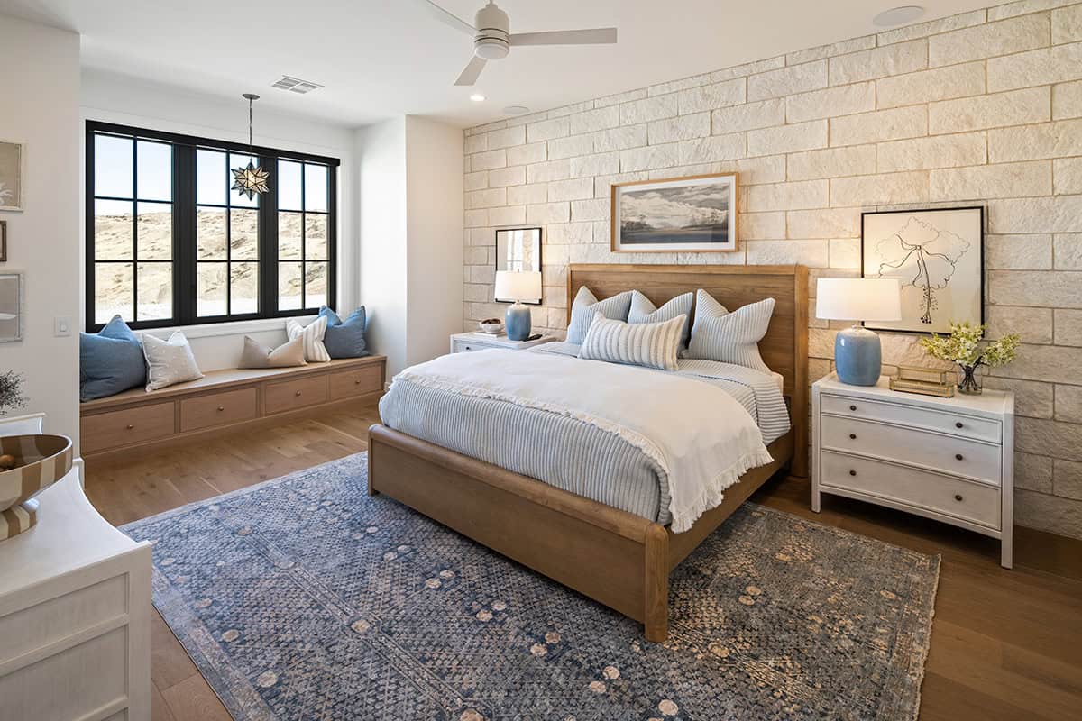 Gorgeous bedroom with stone wall accent and complementary paint colors