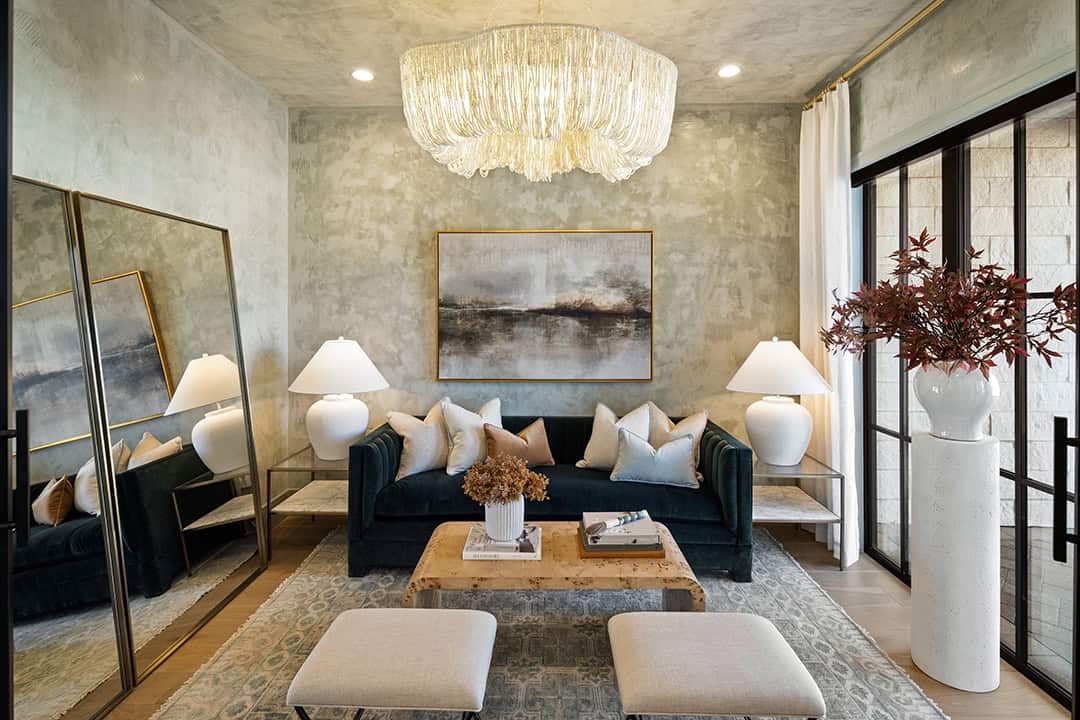 Living room with warm textured wall paint treatment and gorgeous draped chandelier