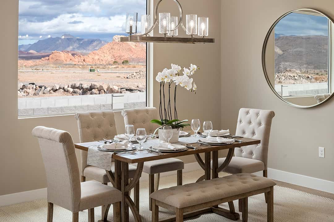 Dining room in earth-tone on-trend taupe paint color with orchids on table and beautiful St. George view.