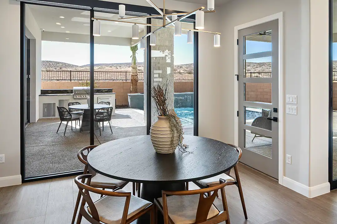 Beautiful modern dining room with a circle table and floor to ceiling patio doors