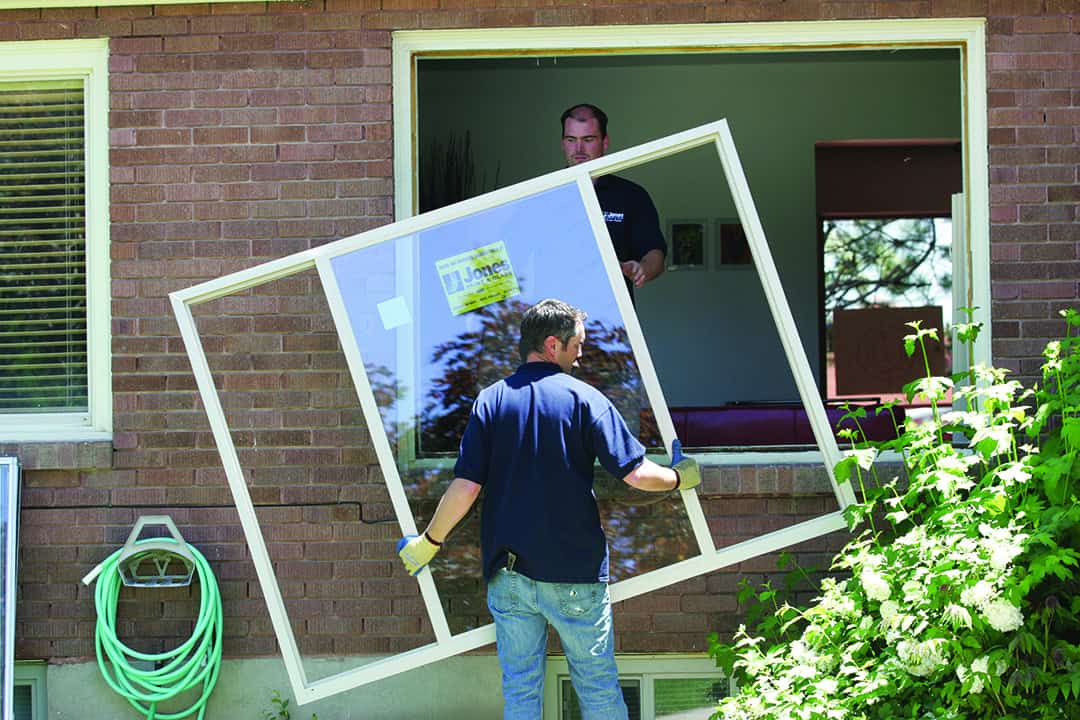 Two experts doing a window installation at home in Utah by Jones Paint and Glass